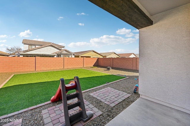 view of yard with a patio area and a fenced backyard