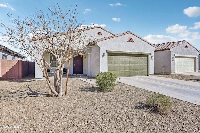 view of front of house featuring an attached garage, a tiled roof, concrete driveway, and stucco siding