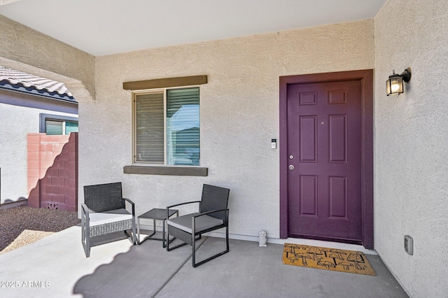 entrance to property with stucco siding