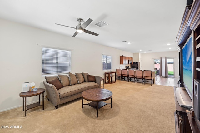 living area with light carpet, baseboards, visible vents, a ceiling fan, and recessed lighting