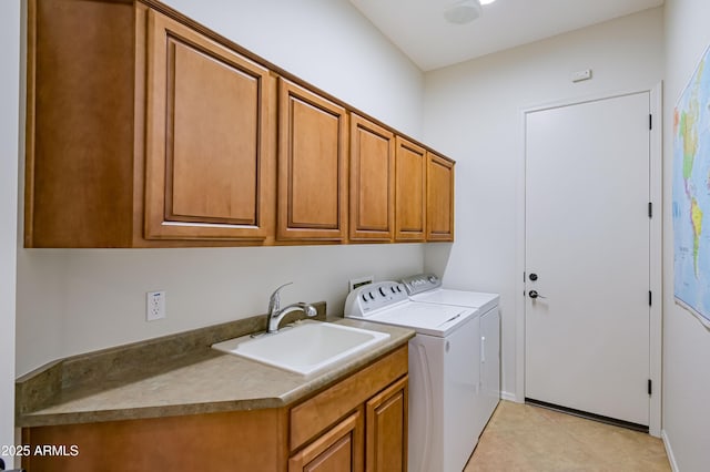 laundry area with washer and clothes dryer, a sink, and cabinet space