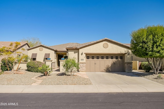 view of front of house with driveway, stone siding, a tiled roof, an attached garage, and stucco siding