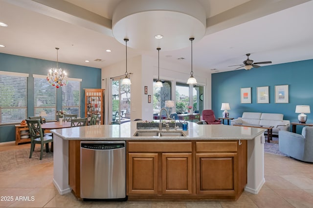 kitchen with open floor plan, decorative light fixtures, a sink, and stainless steel dishwasher