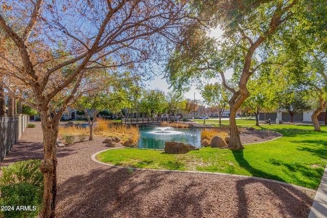 view of community with a yard and a water view