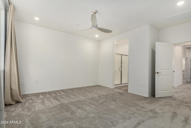 unfurnished room with light colored carpet and ceiling fan