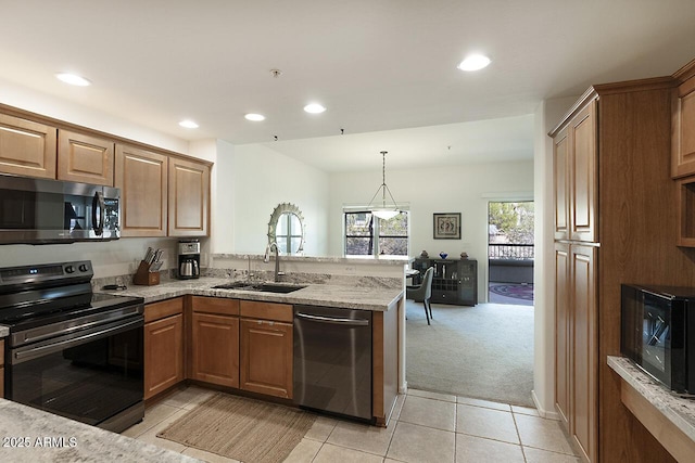 19700 N 76th St Unit 1058, Scottsdale, AZ 85255 - kitchen with a peninsula, light tile patterned floors, light stone countertops, stainless steel appliances, and a sink