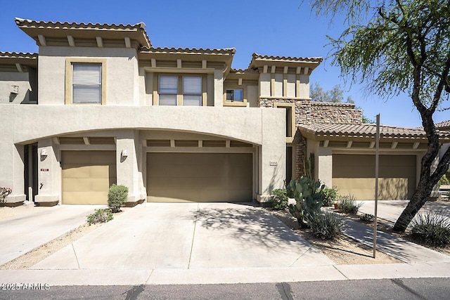 19700 N 76th St Unit 1058, Scottsdale, AZ 85255 - view of front of home with concrete driveway, stucco siding, a tiled roof, and a garage