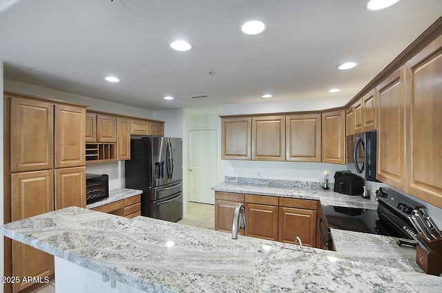 19700 N 76th St Unit 1058, Scottsdale, AZ 85255 - kitchen featuring stainless steel fridge with ice dispenser, black microwave, recessed lighting, light stone counters, and range with electric cooktop