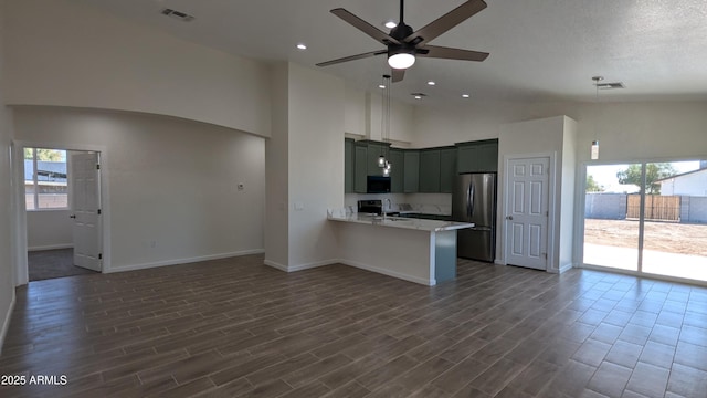 kitchen featuring ceiling fan, kitchen peninsula, light stone countertops, stainless steel appliances, and high vaulted ceiling