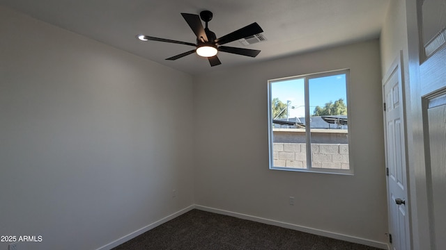 carpeted spare room with ceiling fan