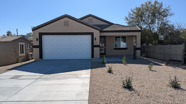 view of front of property featuring cooling unit and a garage