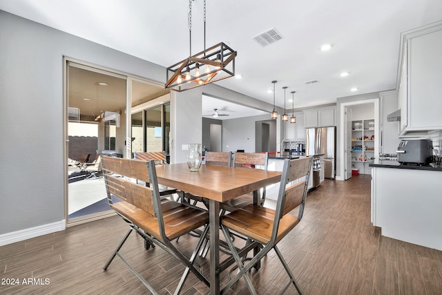 dining room featuring ceiling fan and dark wood-type flooring