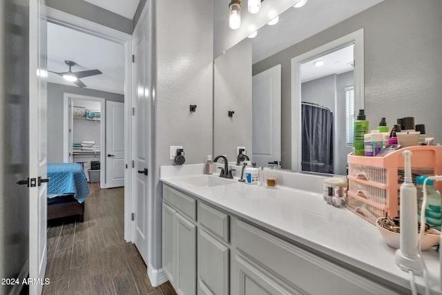 bathroom with ceiling fan, hardwood / wood-style floors, and vanity