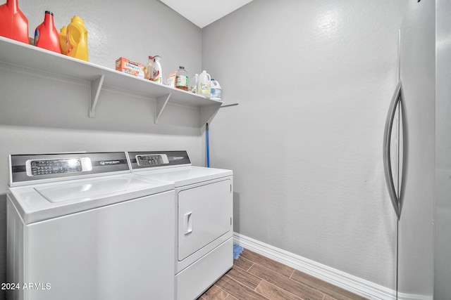 laundry area featuring separate washer and dryer and dark wood-type flooring