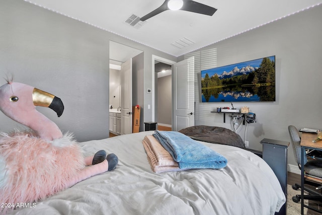 bedroom featuring hardwood / wood-style floors, ceiling fan, lofted ceiling, and ensuite bath