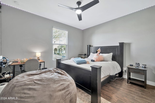 bedroom featuring dark hardwood / wood-style floors, ceiling fan, and lofted ceiling