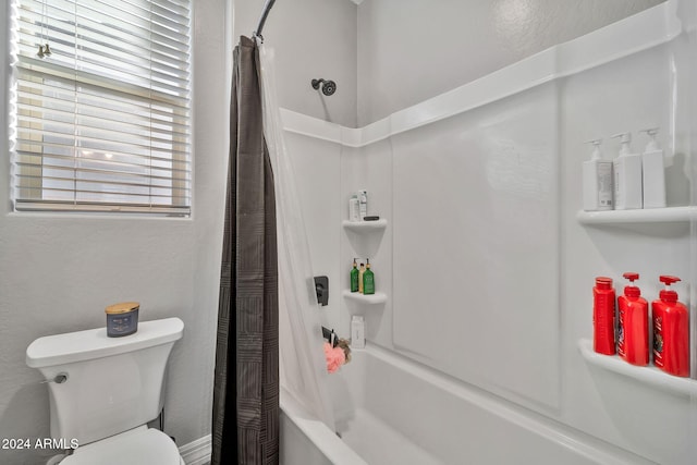 bathroom with toilet and shower / bath combo with shower curtain