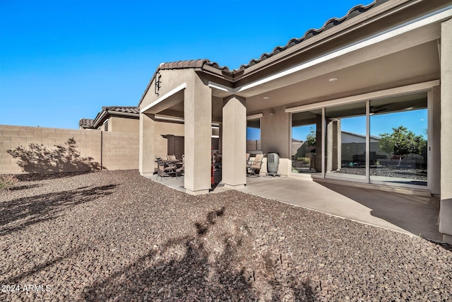 back of property featuring a patio area