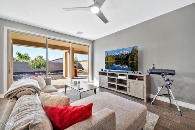 living room with ceiling fan and dark wood-type flooring