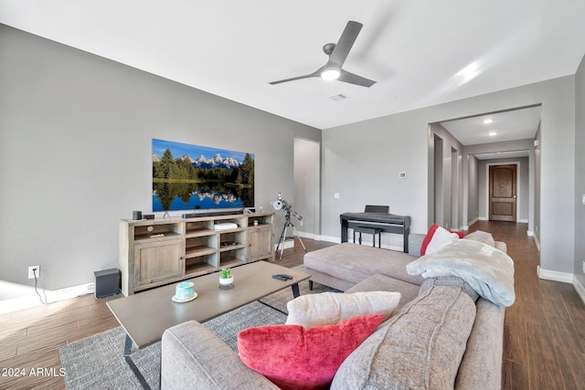 living room with ceiling fan and dark hardwood / wood-style flooring