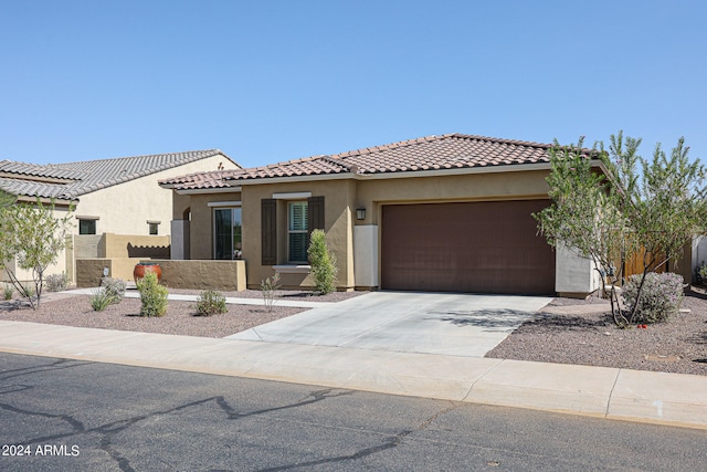 mediterranean / spanish-style home with a garage