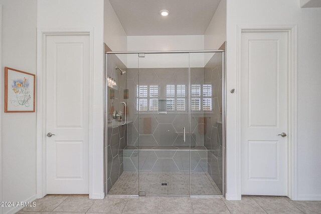 bathroom with tile patterned floors and an enclosed shower