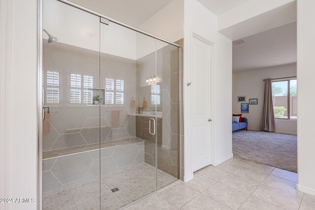 bathroom featuring tile patterned floors and a shower with shower door