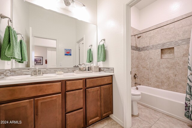 full bathroom with toilet, vanity, tile patterned flooring, and shower / bath combo with shower curtain