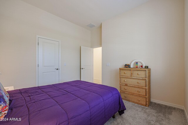 carpeted bedroom with vaulted ceiling