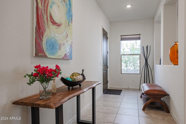 foyer entrance with light tile patterned floors