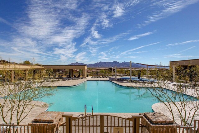 view of swimming pool with a mountain view and a patio