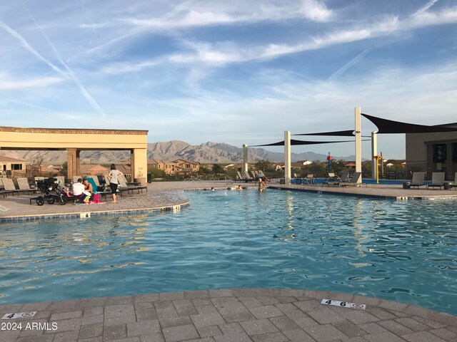 view of swimming pool featuring a mountain view and a patio area