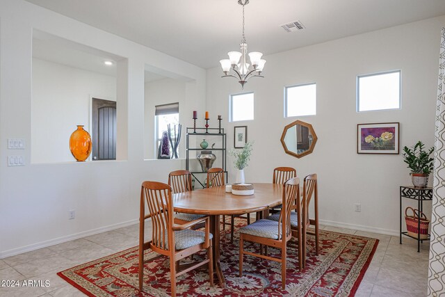 tiled dining space featuring a chandelier