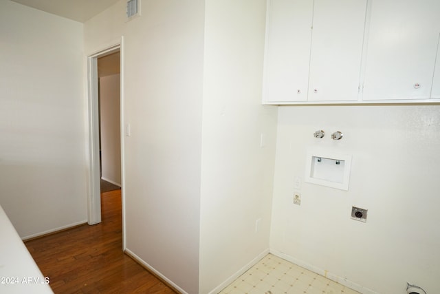 washroom with washer hookup, hookup for a gas dryer, cabinets, light hardwood / wood-style floors, and electric dryer hookup