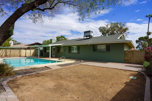 view of pool featuring cooling unit and a patio area