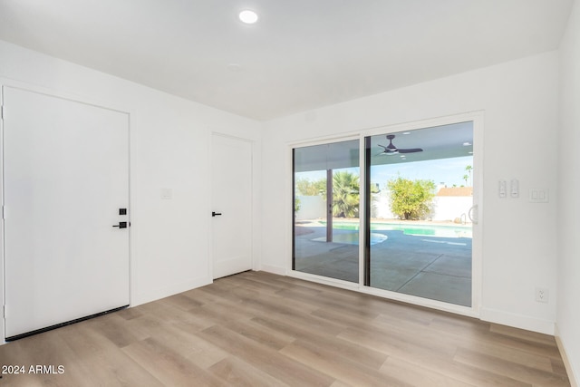 empty room with ceiling fan and light wood-type flooring