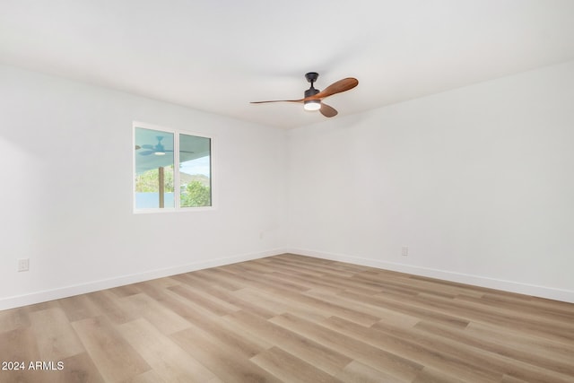 spare room with light wood-type flooring and ceiling fan