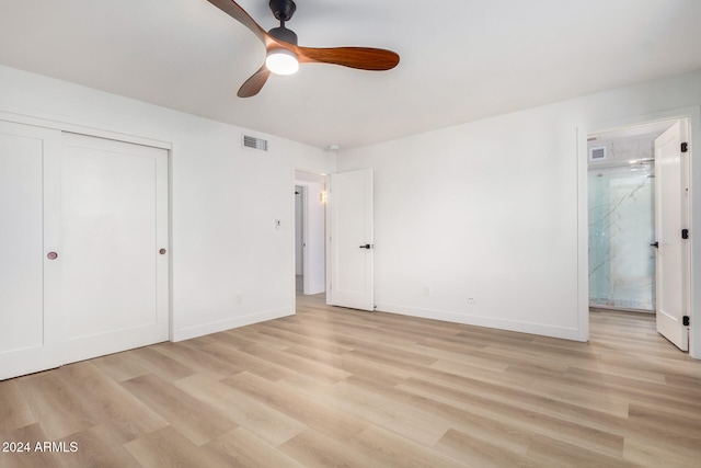 unfurnished bedroom with light hardwood / wood-style flooring, a closet, and ceiling fan