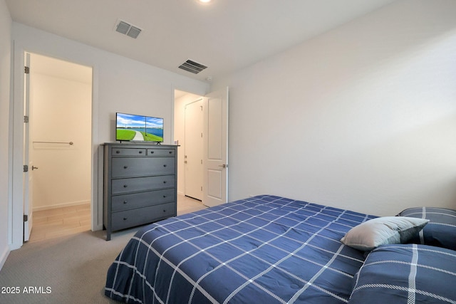 bedroom with visible vents and light colored carpet