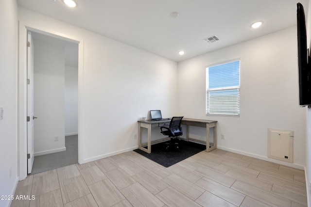 unfurnished office featuring recessed lighting, visible vents, and baseboards