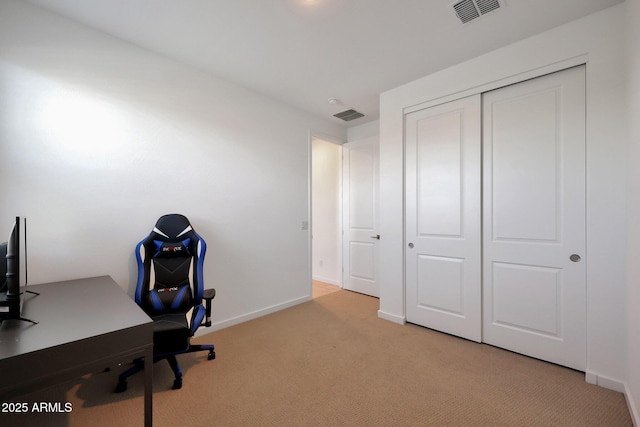 office area with light colored carpet, visible vents, and baseboards