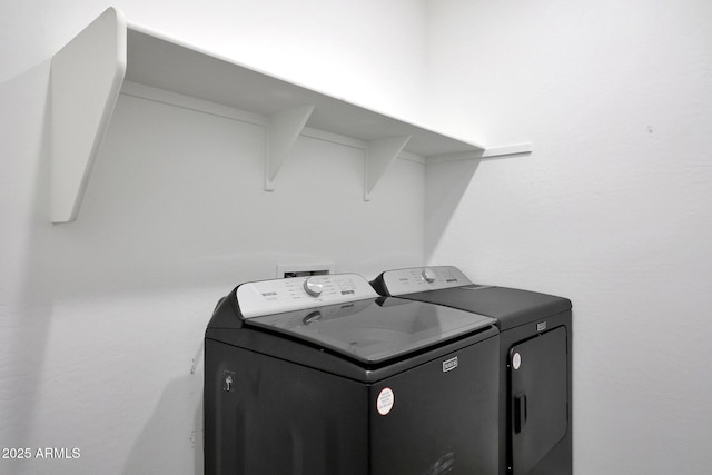 washroom featuring laundry area and separate washer and dryer