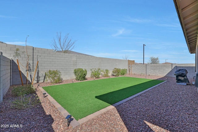 view of yard with a fenced backyard