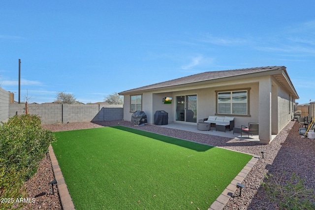 rear view of house featuring a patio area, stucco siding, an outdoor hangout area, and a fenced backyard