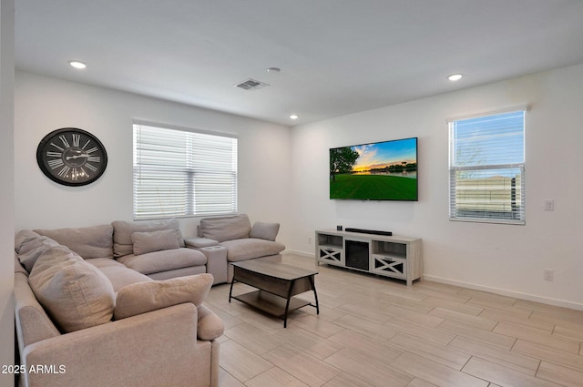 living area with recessed lighting, baseboards, and visible vents