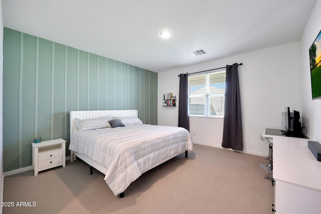 bedroom with visible vents, light colored carpet, and baseboards