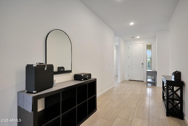 foyer with recessed lighting and baseboards