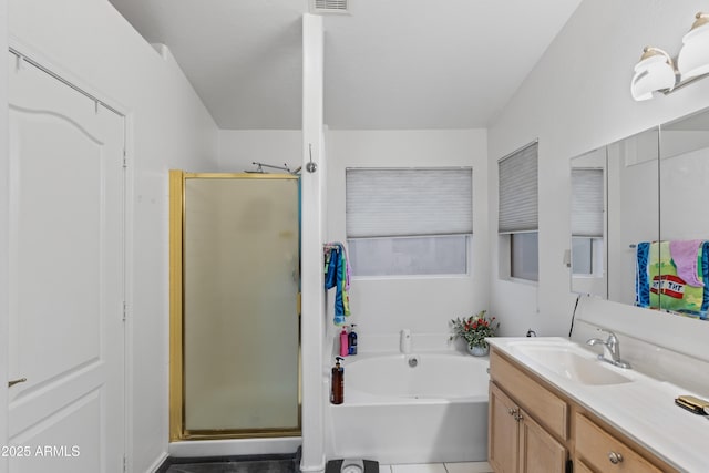 bathroom with vanity and shower with separate bathtub