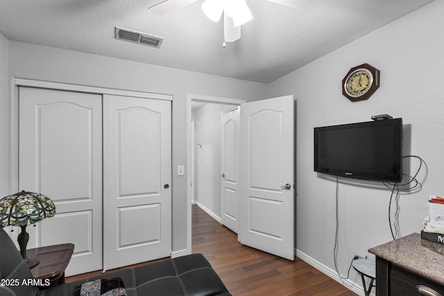 office space featuring ceiling fan and dark hardwood / wood-style floors