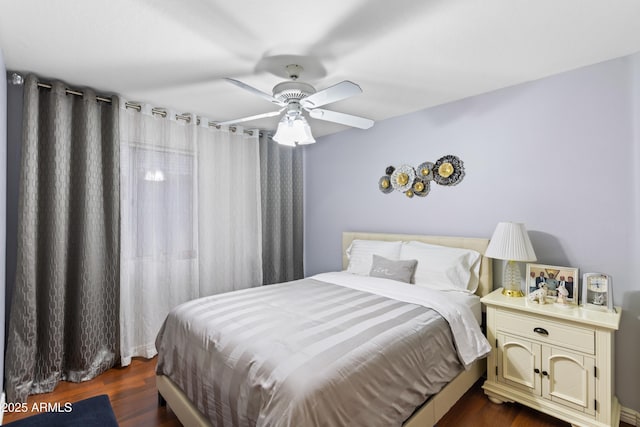 bedroom with ceiling fan and dark hardwood / wood-style flooring